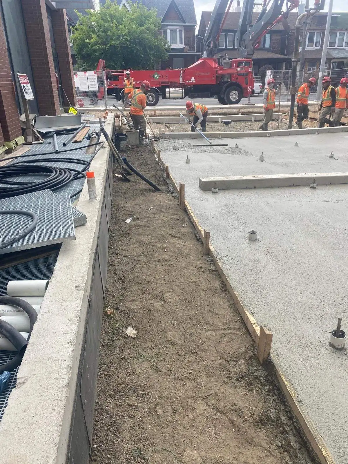 Empire Paving crew performing concrete pour and finishing work at a commercial site in Oakville, Ontario.