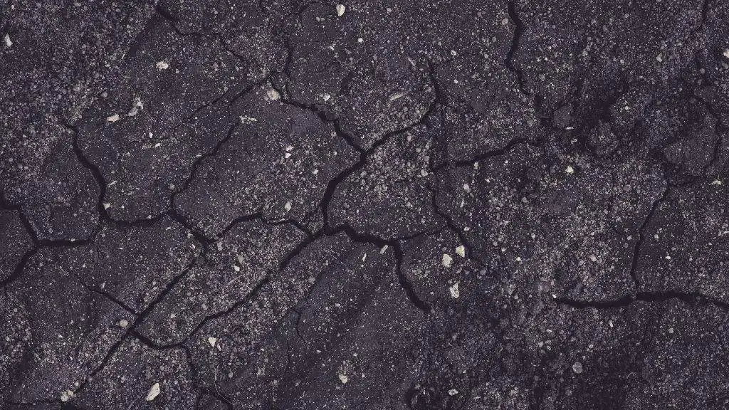 Top-down close-up of severely cracked and deteriorated asphalt pavement surface needing fall maintenance and repair by Empire Paving. 